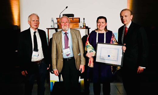 Dr Anne Velenturf (second from right) receiving the Poul La Cour award at an event.