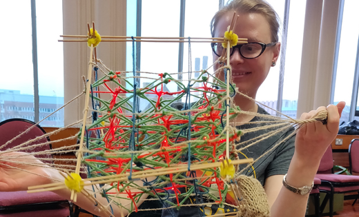 Dr Philippa Shepley demonstrating a crystal structure that generates electricity with force, in preparation for the ‘Bragg-ing about Leeds’ stall at Be Curious 2020. March 2020