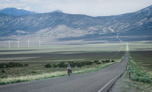 Antony Butcher cycles through a mountainous landscape.