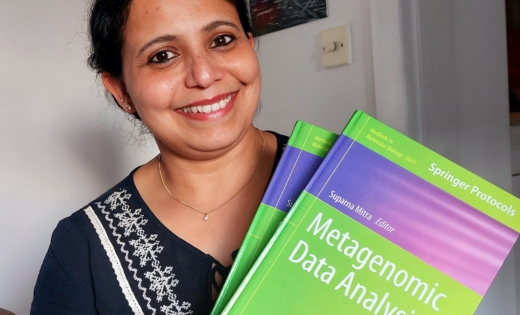 Dr Suparna Mitra holding her book ‘Metagenomic Data Analysis’ 