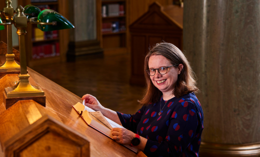 Claire Knowles at a desk in the Brotherton Library