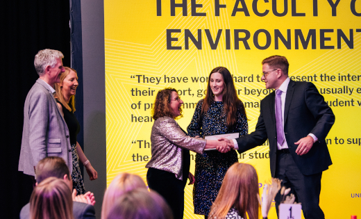 DVC Jeff Grabill presents the award on stage to representatives of the Faculty of Environment.