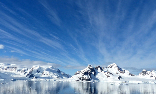 Antarctic shore with a skyline of mountains
