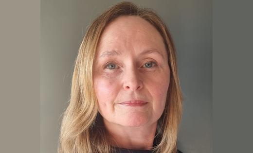 Professor Karen Spilsbury in front of a grey background