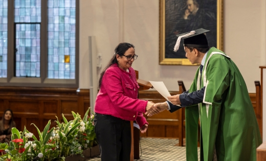 A colleague receiving their award in a graduation ceremony