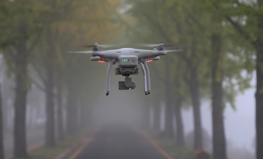 A drone flying through the misty park.