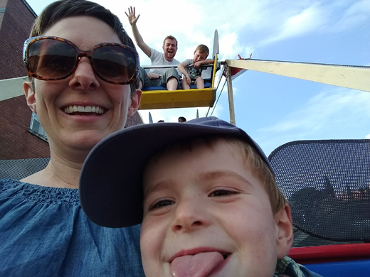 Dr Lucie Middlemiss with her son, Ralph, enjoying the Ferris wheel at last year’s Staff Festival, with Lucie’s husband, Derek, and Ralph’s big brother, eight-year-old George, behind them. June 2019