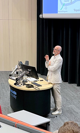 Speaker Mark Miodownik  talking about the Big Repair Project in a lecture theatre