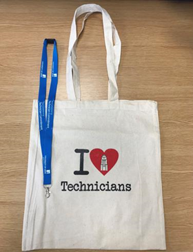A shopping bag showing "I heart Technicians" on it.