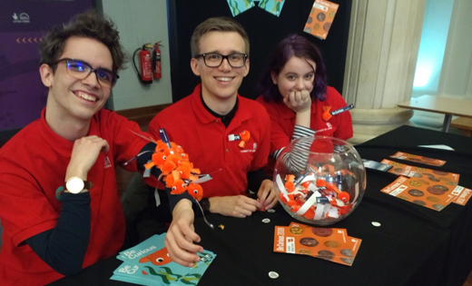 Students Aidan Jeeves, Jordan Tinkler and Cait Meredith distribute an arm-y of bugs at Be Curious 2018