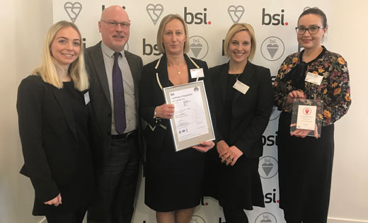 Residential Services team members being awarded their BSI Certificate of Registration