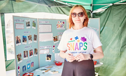 SNAPS Community Fundraising Manager, Jenny Sellers, manning the charity's Staff Festival stall. July 2019
