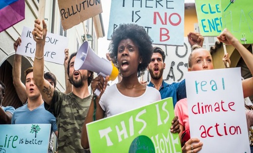 Individuals holding sign boards for climate change protest